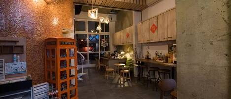 A cozy interior with a telephone booth, wooden cabinets, and a bar area.