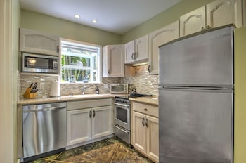 Full-size fridge, microwave, oven, stovetop at Hideaway Cove Poipu Beach