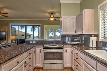 Full-size fridge, microwave, oven, stovetop at Hideaway Cove Poipu Beach