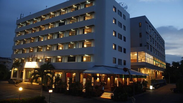 A multi-story hotel with a modern design, featuring a prominent entrance with steps and a covered outdoor area. - Boonsiam Hotel (Krabi)