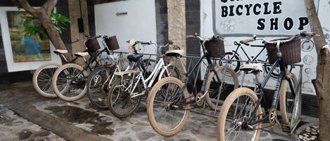 A row of bicycles parked outside a shop named "SCALLYWAG BICYCLE SHOP".