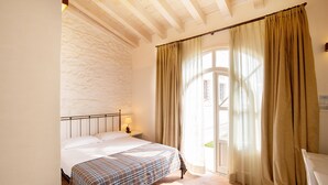 A bedroom with a bed, a nightstand, a lamp, and a window with curtains. - Residence Corte San Carlo (Lazise)