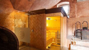A modern bathroom with a glass shower enclosure, a wooden vanity, and a stone-tiled floor. - Residence Corte San Carlo (Lazise)