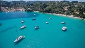 A coastal town with a marina filled with sailboats. - Amfitriti Hotel (Paxos)