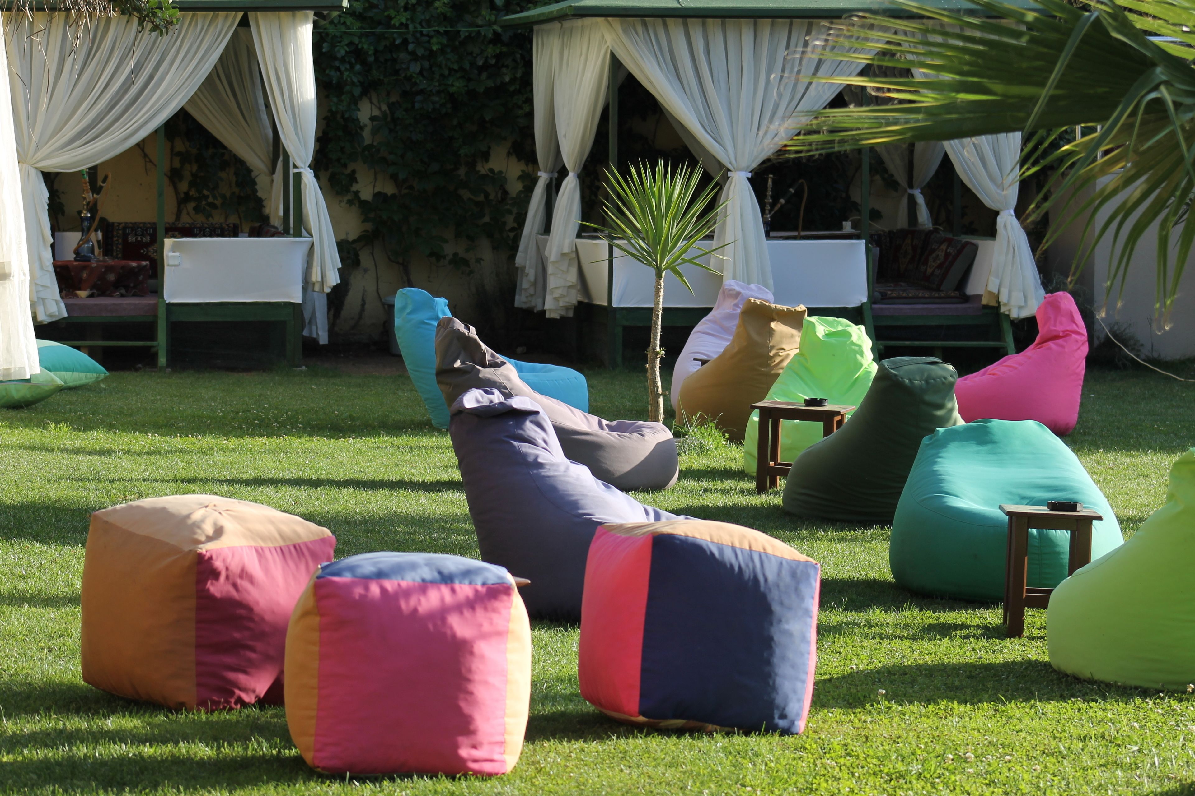 A garden area with outdoor seating and a covered structure.