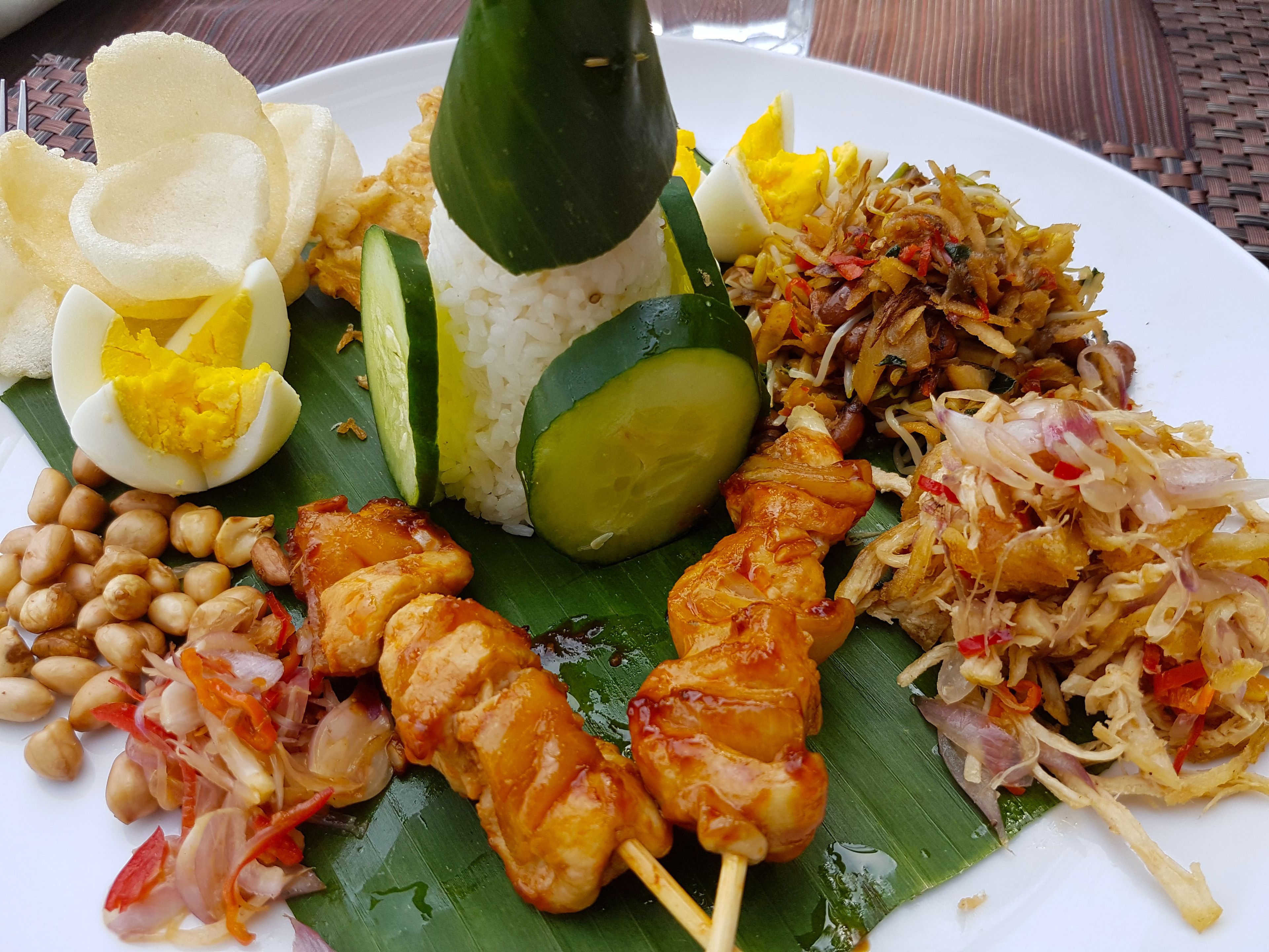 A plate of food with rice, vegetables, and meat.