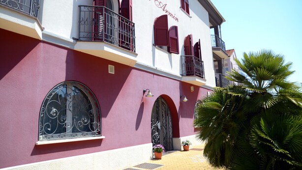 A building with arched windows and balconies, labeled "Villa Armin." - Villa Armin (Rovinj)