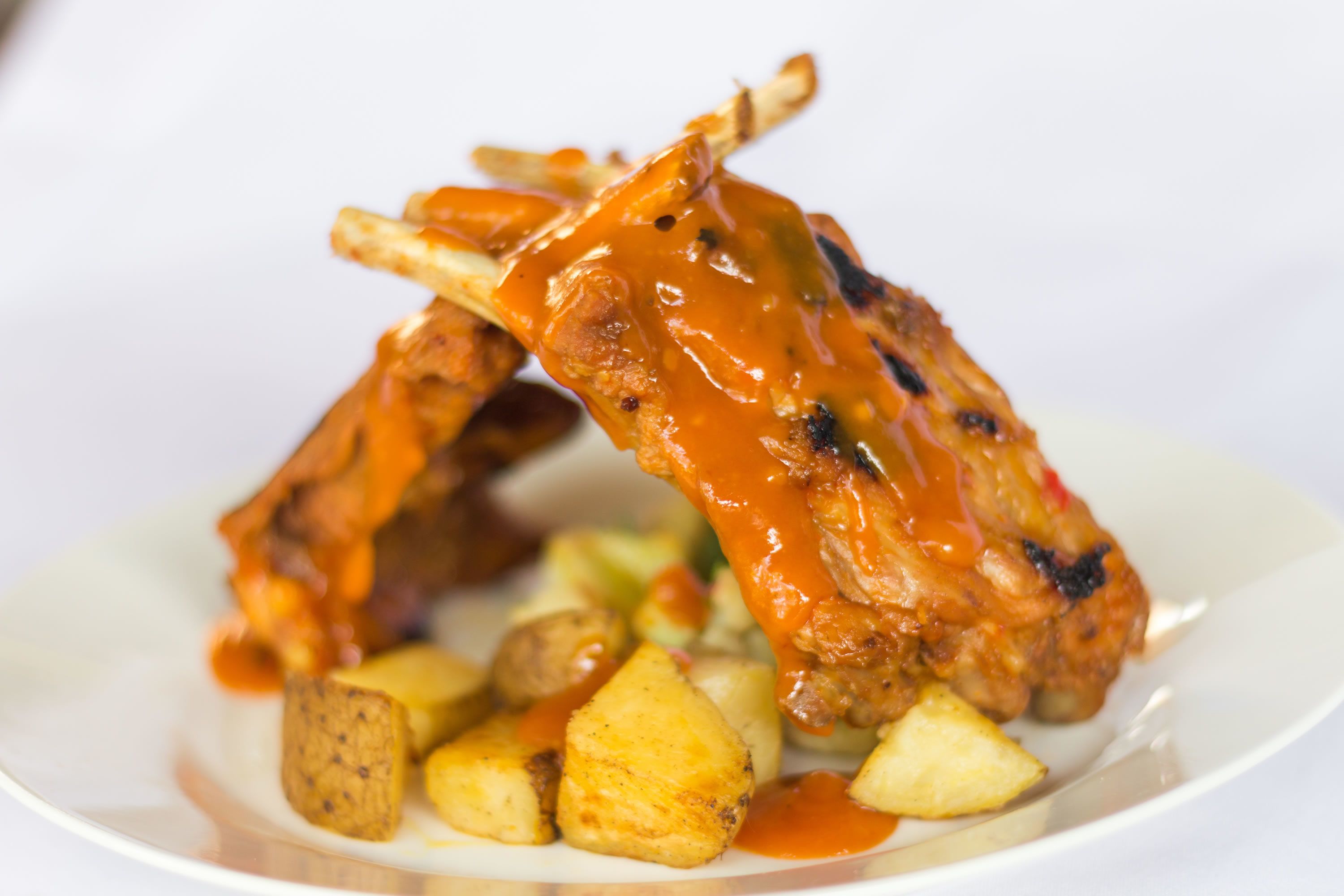A plate with grilled meat and roasted potatoes.