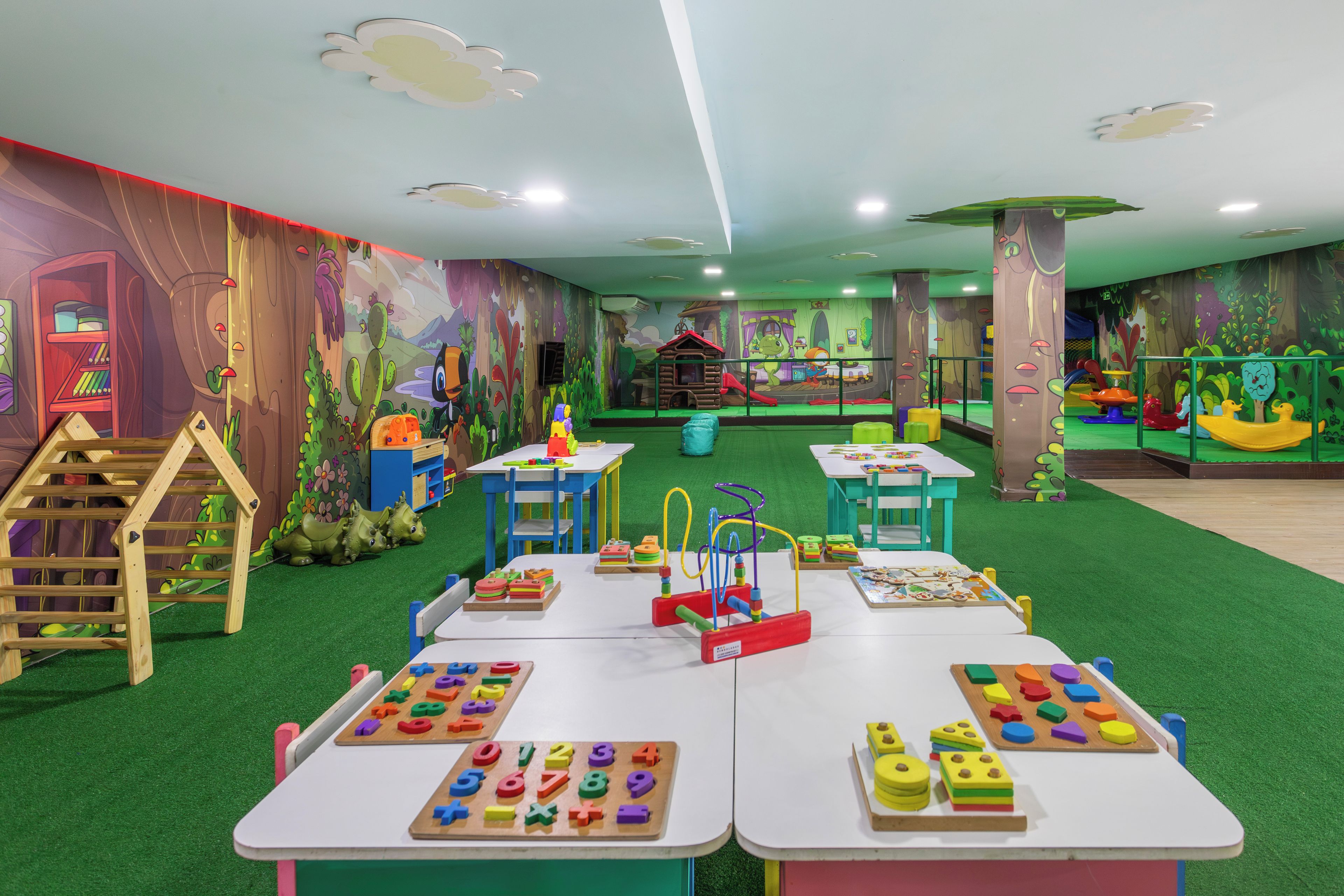 A children's play area with tables, chairs, and educational toys.