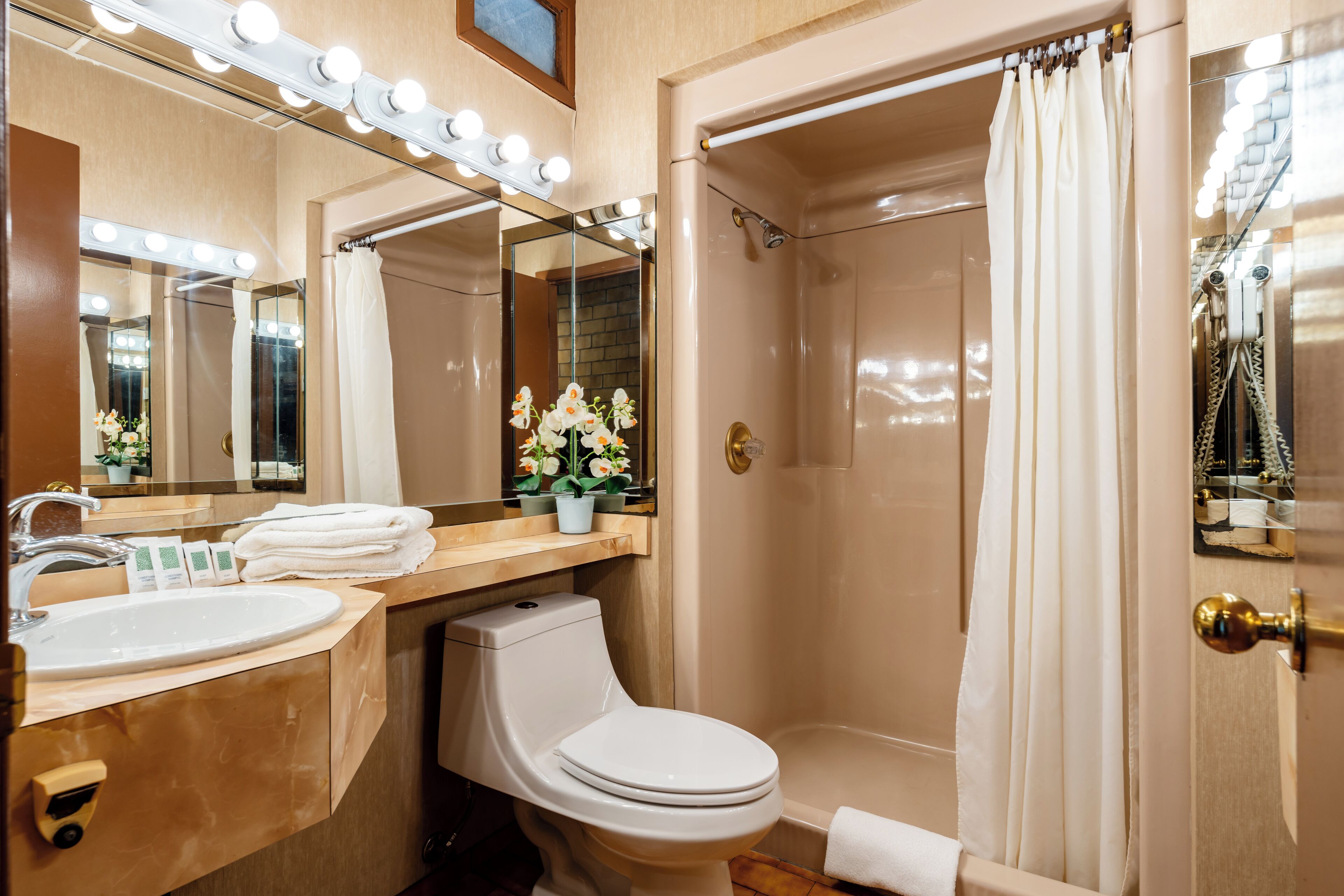 A bathroom with a sink, toilet, and shower.