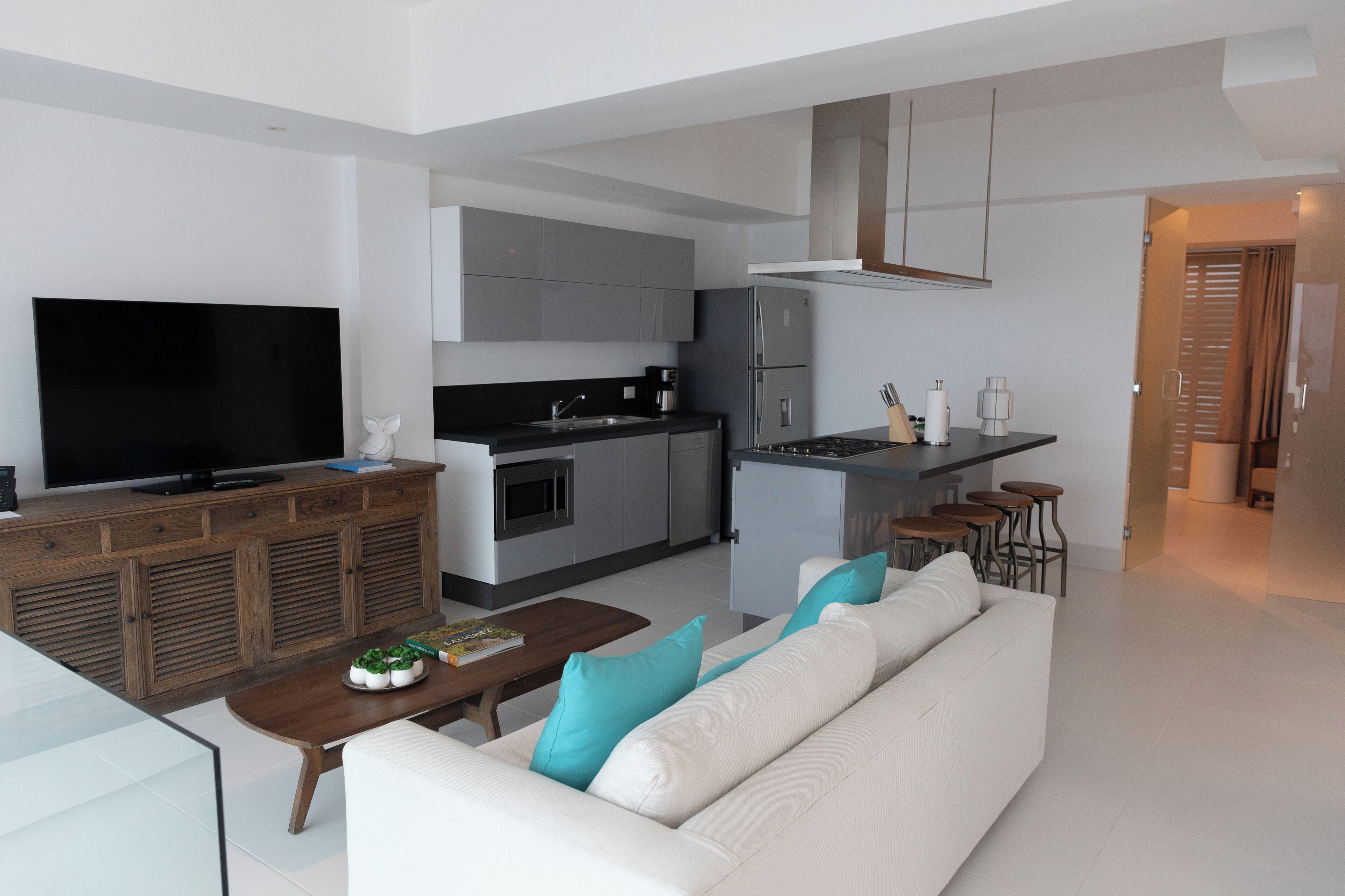 A modern living room with a sofa, coffee table, and a TV.