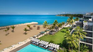 A resort with a pool, beach, and ocean view.