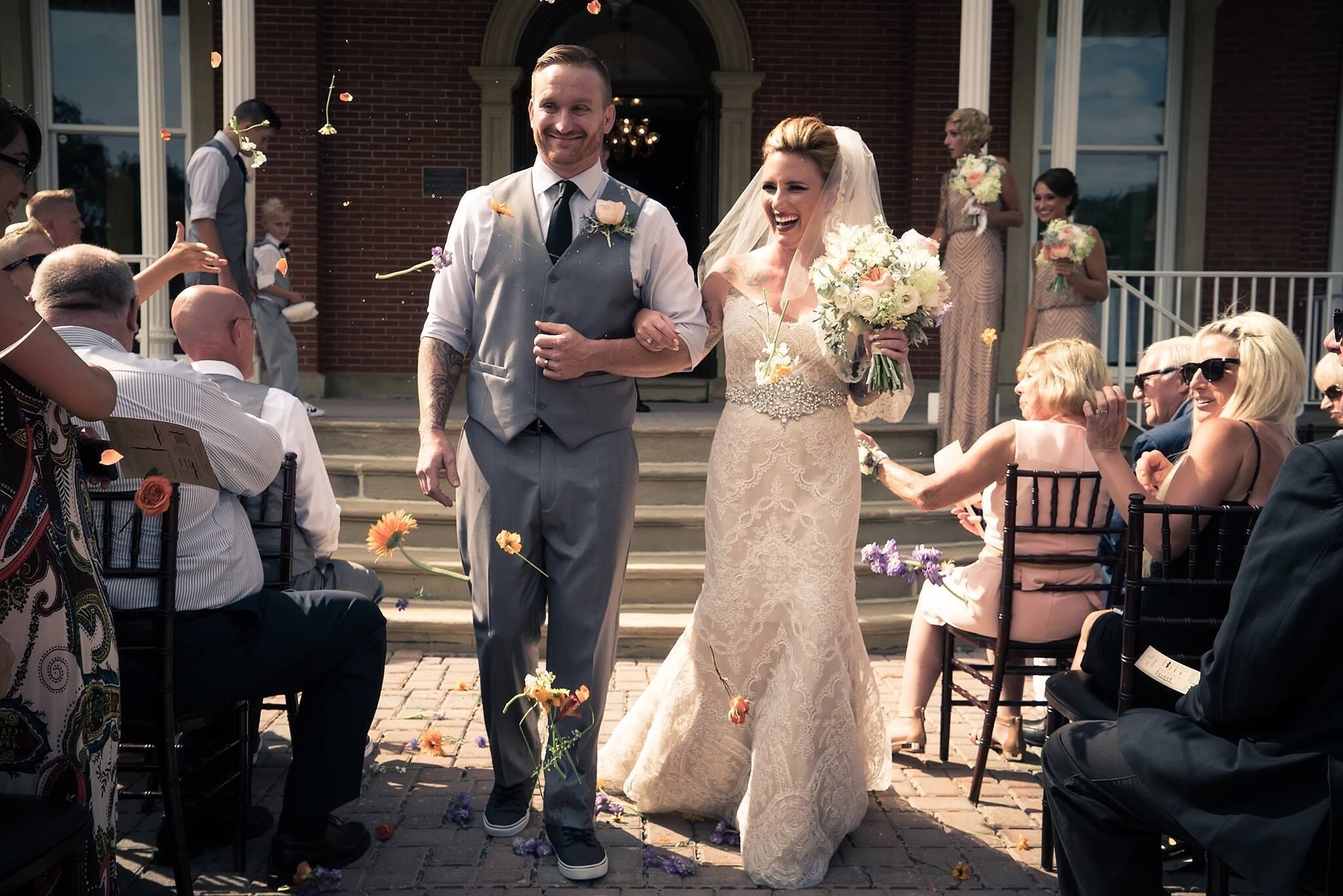 A wedding ceremony with guests seated on chairs arranged in rows.