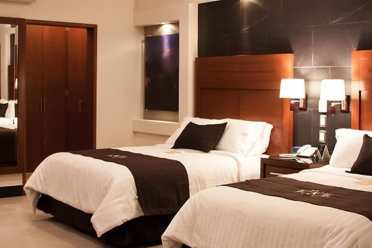 Luxe beddengoed, een minibar met enkele gratis items