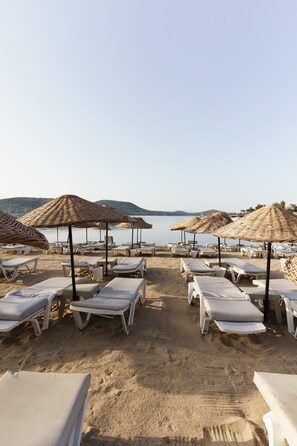 On the beach, sun loungers, beach umbrellas
