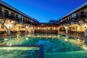 A hotel with a central pool, multiple balconies, and indoor seating areas. - Costa Bitezhan Hotel (Bodrum)