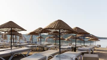 On the beach, sun-loungers, beach umbrellas