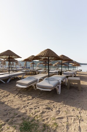 On the beach, sun-loungers, beach umbrellas