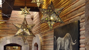 A hallway with brick walls, tiled flooring, and star-shaped hanging lights. - Luxury Rancho la Loma (San Felipe)
