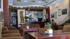 A hotel lobby with seating areas, a reception desk, and a bar. - Dalat Green City Hotel (Xuan Huong - Da Lat)
