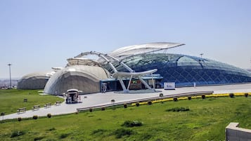 A modern architectural building with a large glass dome and a smaller adjacent structure.