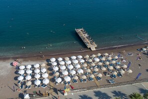 Private beach, black sand, sun loungers, beach umbrellas