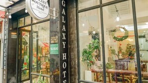 The exterior of the Galaxy Boutique Hotel with a reception area visible through the glass doors.