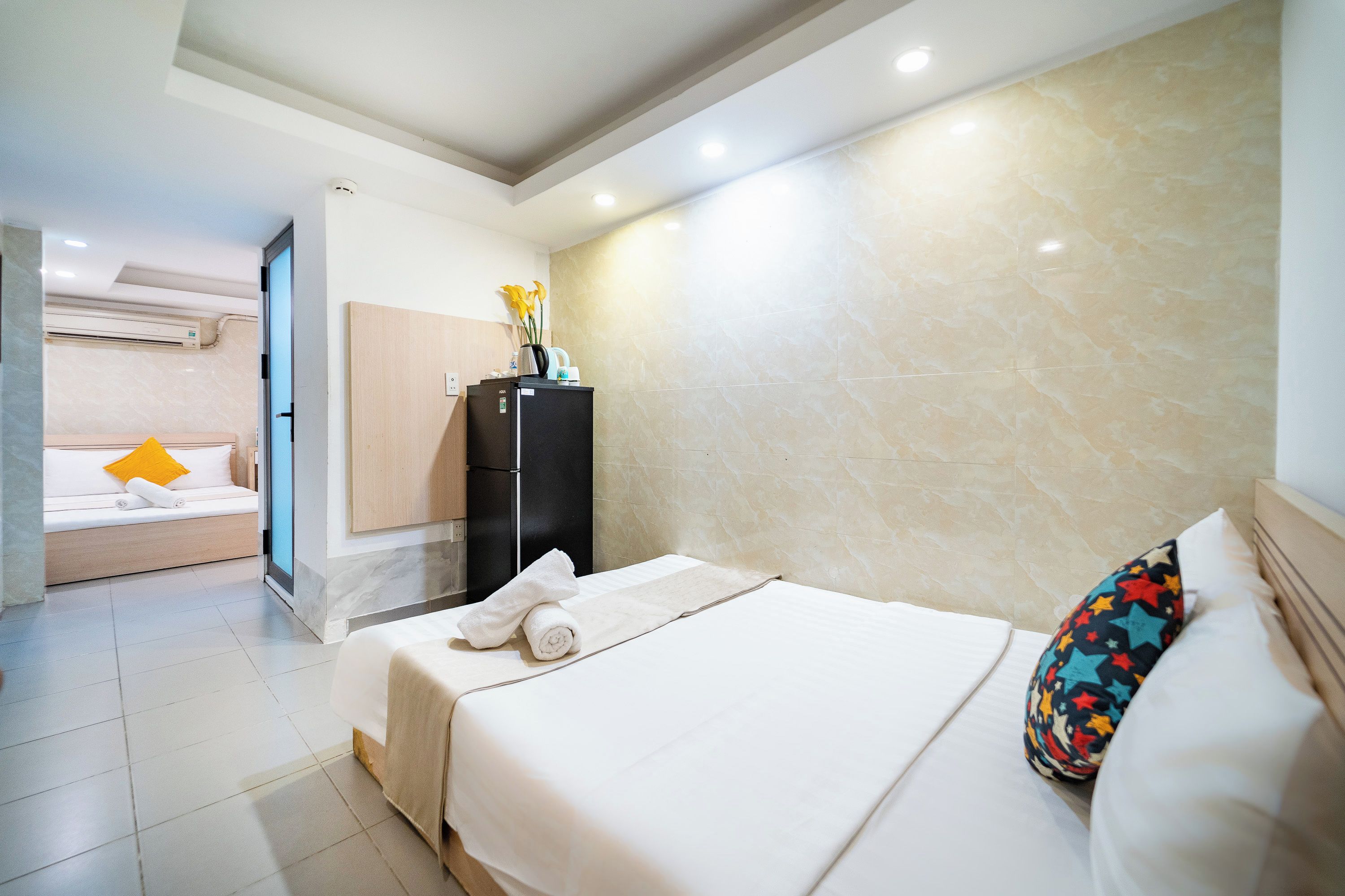 A hotel room with a bed, a wardrobe, a bathroom, and a seating area.