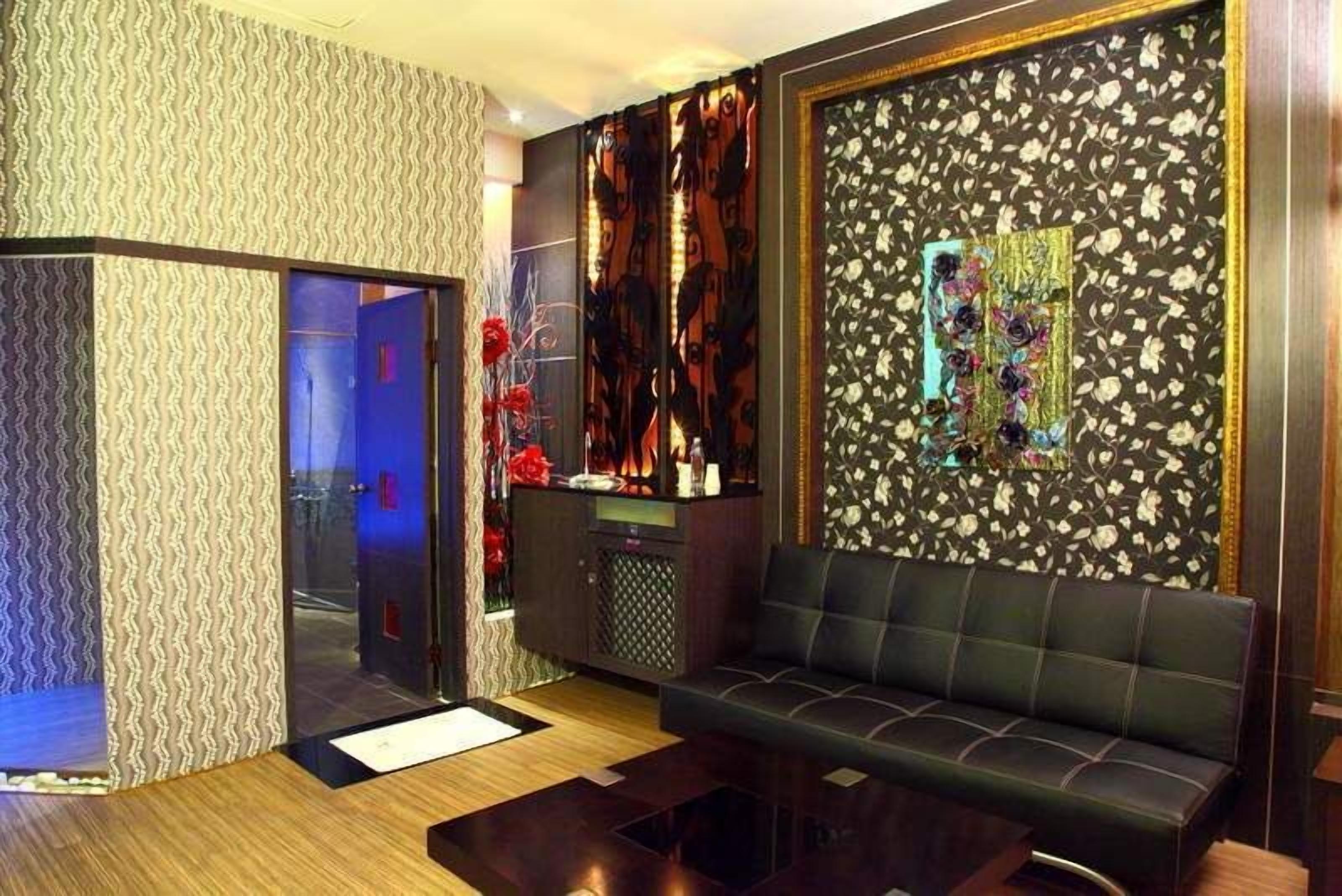A modern room with a sofa, a cabinet, and a decorative wall.