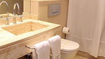 A bathroom with a sink, toilet, and bathtub.