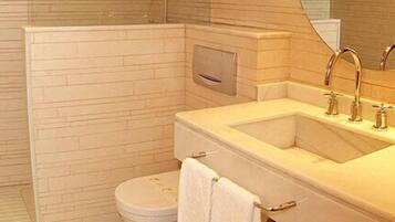 A bathroom with a bathtub, a sink, and a toilet.