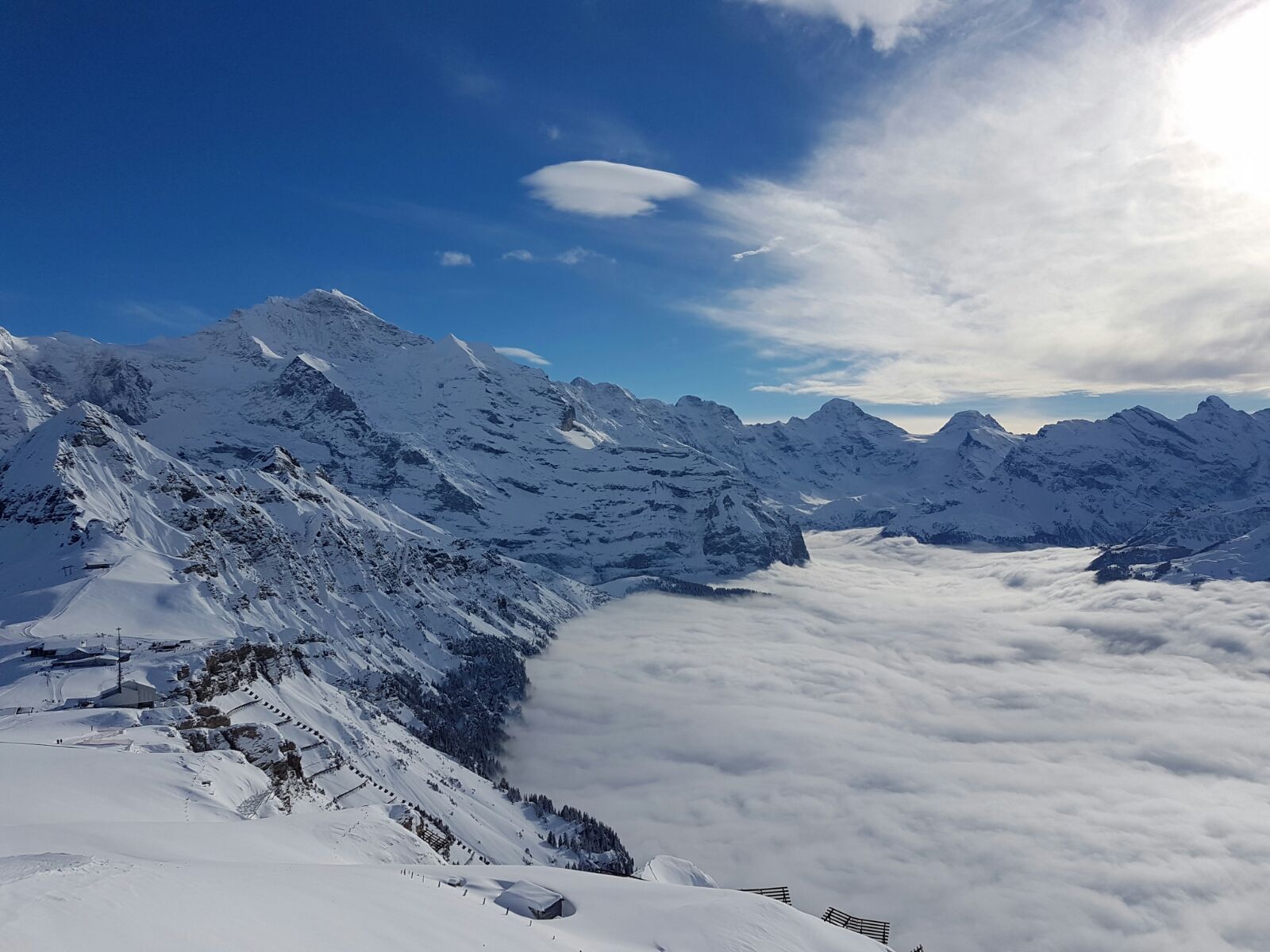 A snow-covered mountain landscape with a clear sky.