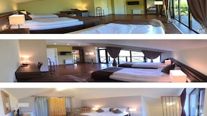 Een hotelkamer met twee bedden, een bureau, een stoel en uitzicht op het landschap.