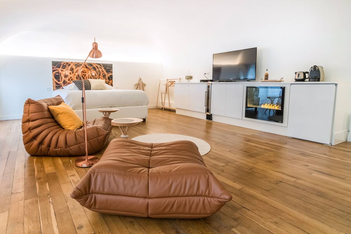 A modern living room with a sofa, a coffee table, and a TV.