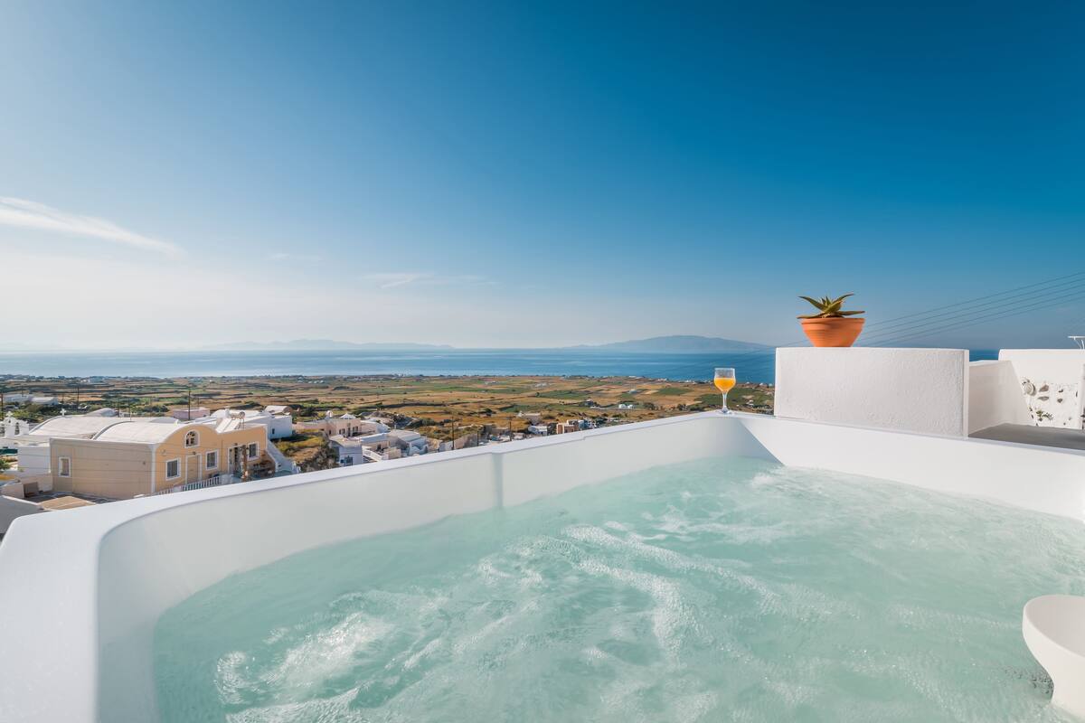 A hot tub with a view of a coastal landscape.