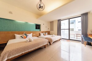 A hotel room with two beds, a large window, a dining area, and a modern chandelier. - Plentiful Inn (Hengchun)