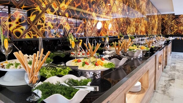 A buffet with various food items and utensils. - Duqqan Deluxe Hotel (Kusadasi)