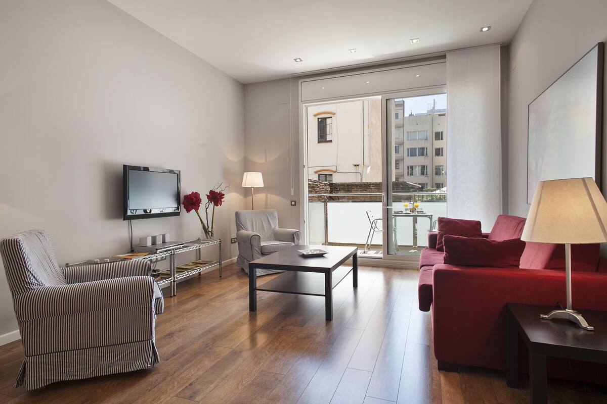 A modern living room with a sofa, armchair, and a coffee table.