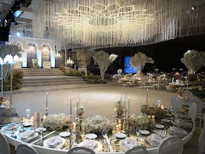 A banquet hall with tiered seating, chandeliers, and floral arrangements. - Pullman Istanbul Airport and Convention Center Hotel (Istanbul)