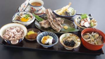A tray with various dishes including rice, soup, and seafood.