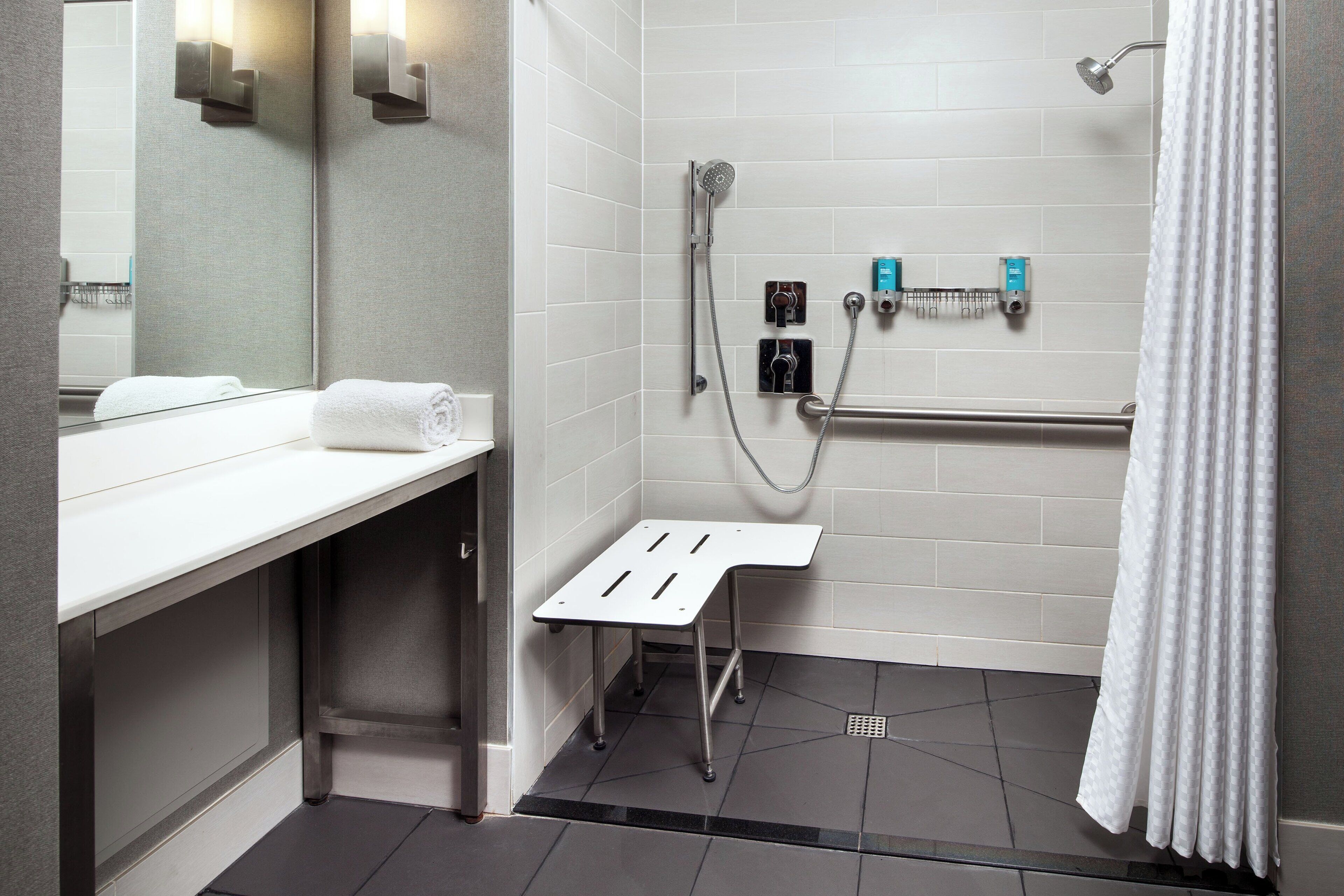 designer toiletries, hair dryer, towels