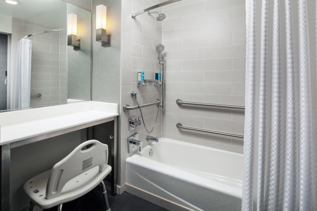 designer toiletries, hair dryer, towels