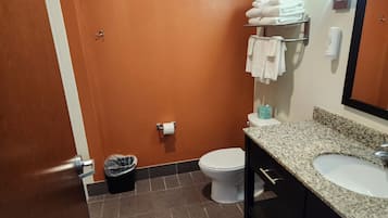 Baño con inodoro, lavamanos y toallero.