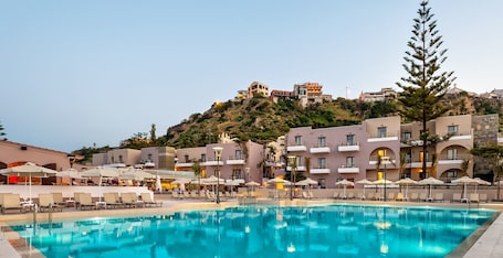 Outdoor pool, pool umbrellas, pool loungers. Porto Platanias Village