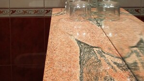 A bathroom with a granite countertop, a towel rack, and a glass jar. - Hotel Puerta De Javalambre (La Puebla de Valverde)