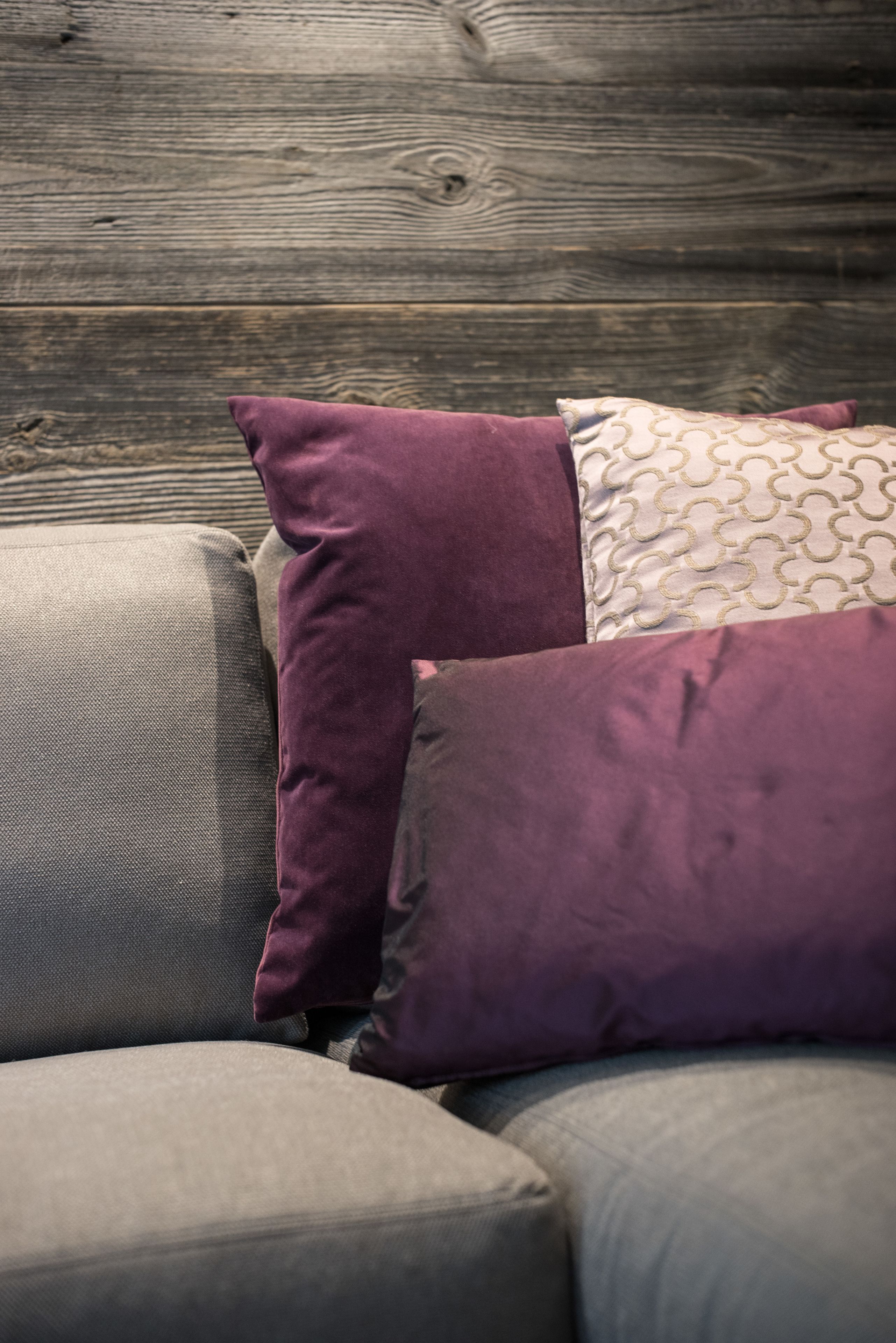 A section of a sofa with multiple cushions.