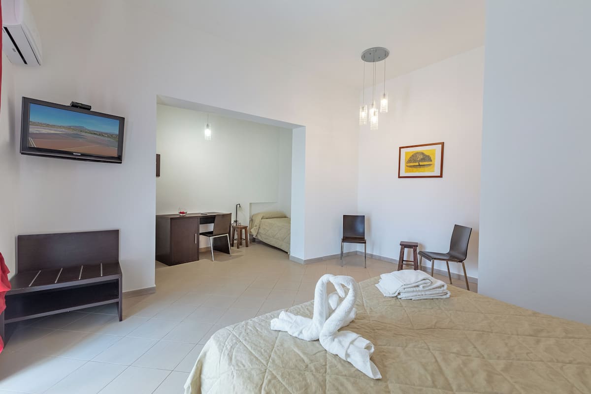 Triple Room | Minibar, in-room safe, individually decorated, desk