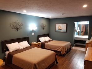 A hotel room with two beds, a nightstand, a painting, and a bathroom visible through an open door. - Brown's Motel Aberdeen (Aberdeen)