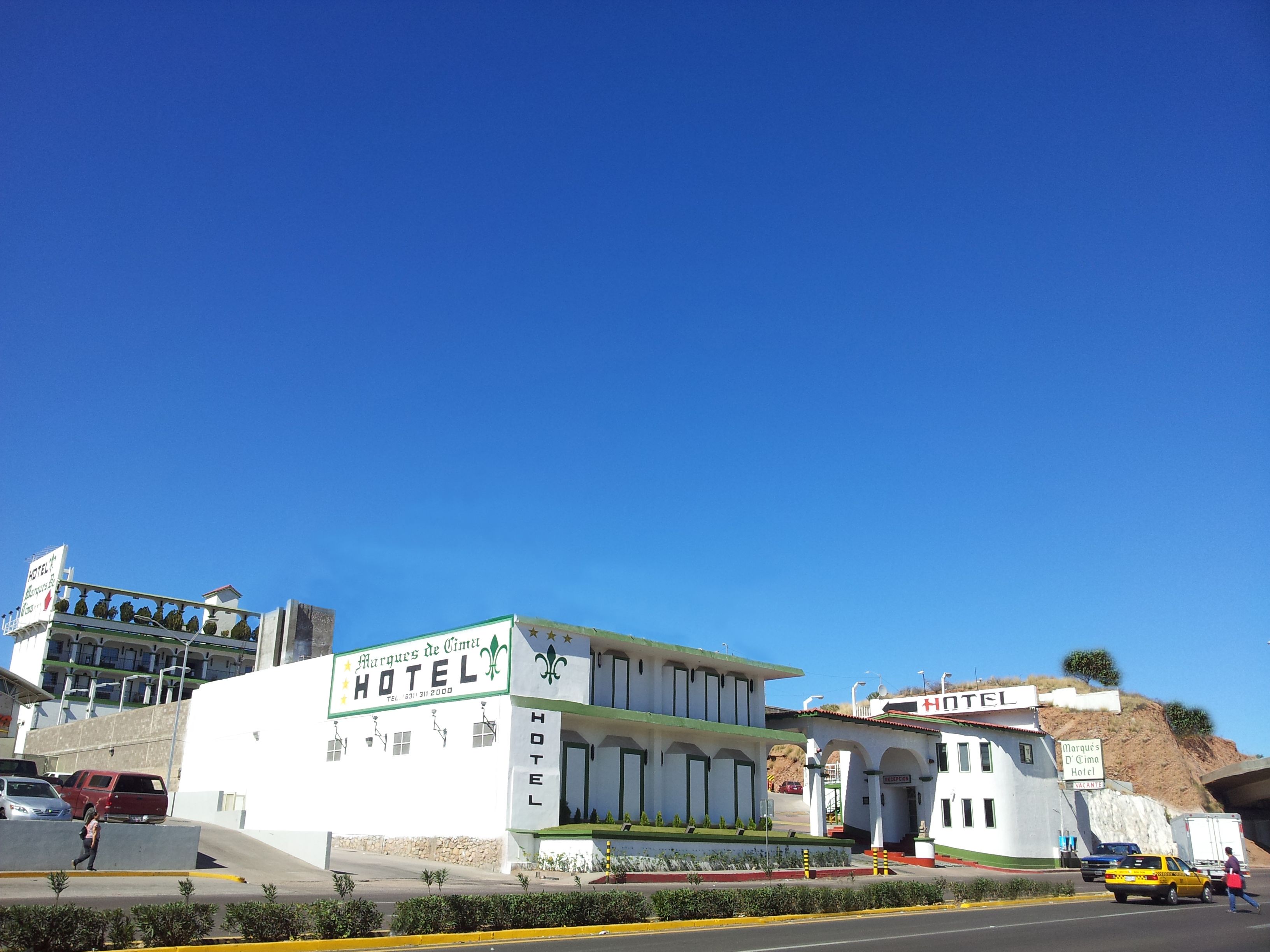 Ein Hotel mit auffälliger Beschilderung, flachem Dach und gut sichtbarem Eingang.