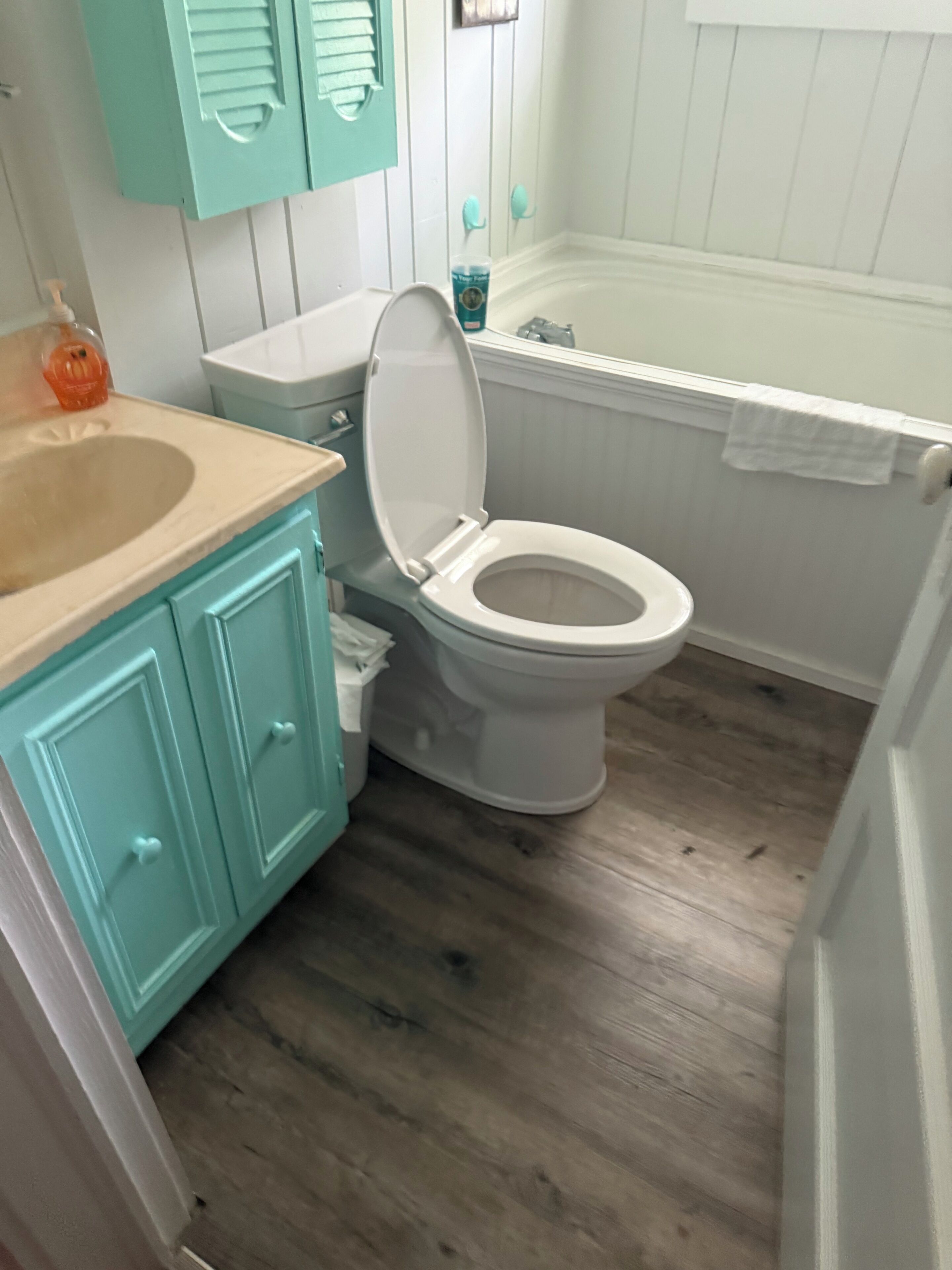 A bathroom with a toilet, a sink, and a bathtub.